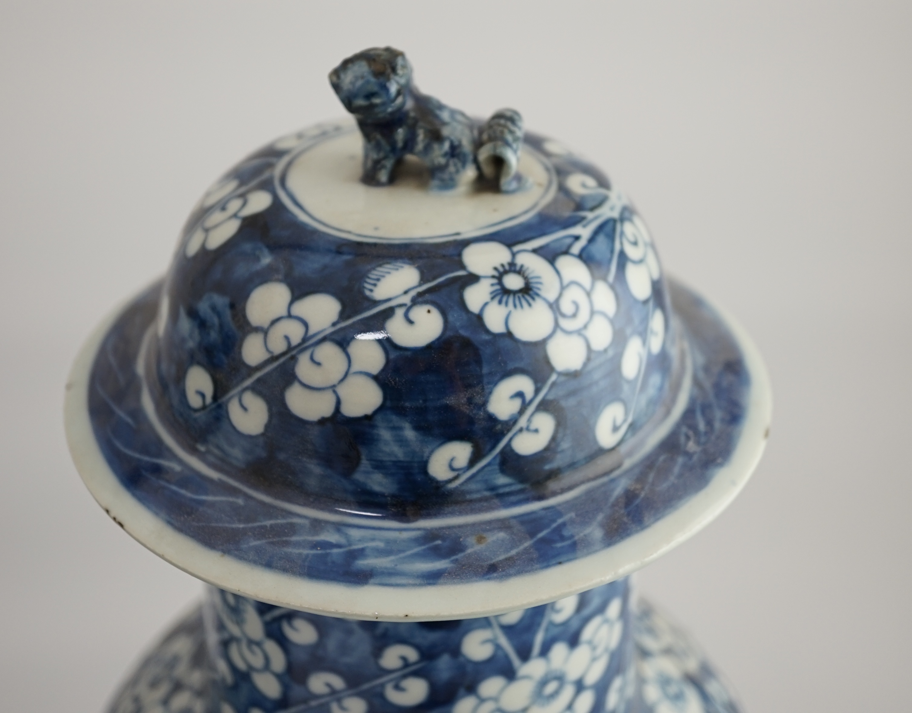 A pair of large Chinese blue and white ‘prunus’ baluster vases and covers, 19th century